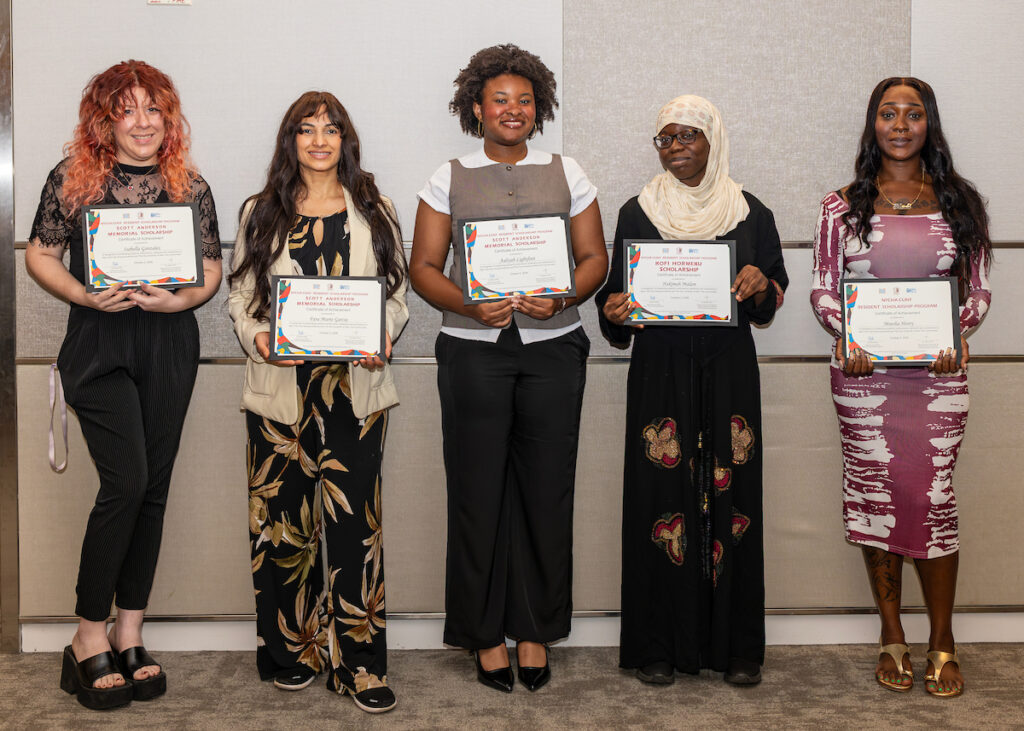 Five individuals stand side by side, each holding a framed certificate, dressed in formal or semi-formal attire against a neutral backdrop.