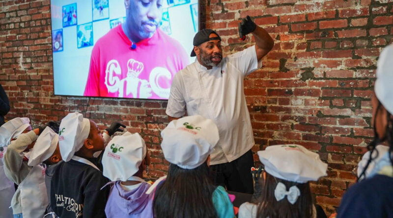 male chef talking to children