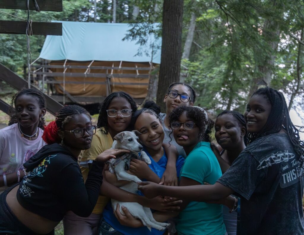 group of teens and tween girls with a small dog