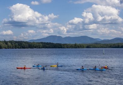 girls boating in canoes on a lake
