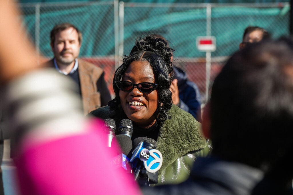 a woman speaks into microphones