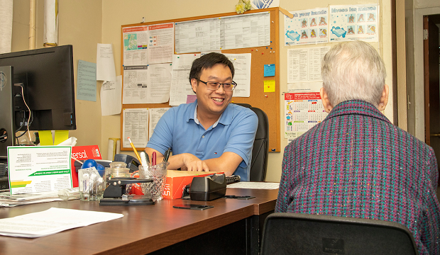 Grayson Lin assisting a resident. Grayson Lin assisting a resident.