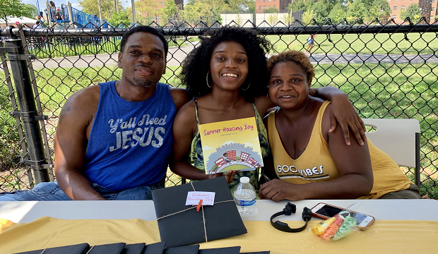 Shaniqua Lewis with her parents and her book. Shaniqua Lewis with her parents and her book.