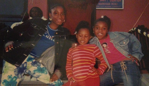 Shaniqua Lewis (right) as a child with friends outside of a community center. Shaniqua Lewis (right) as a child with friends outside of a community center.