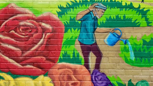 Photos courtesy of Thrive Collective. painted mural with people in a flower garden