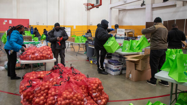 Turkey and produce giveaway at Melrose Classic Community Center. people sort groceries