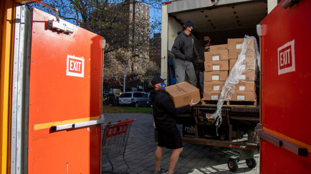 Turkey and produce giveaway at Melrose Classic Community Center. men unloading boxes off a truck