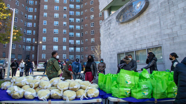 Turkey and produce giveaway at Melrose Classic Community Center. people stand outside at frozen turkey giveaway