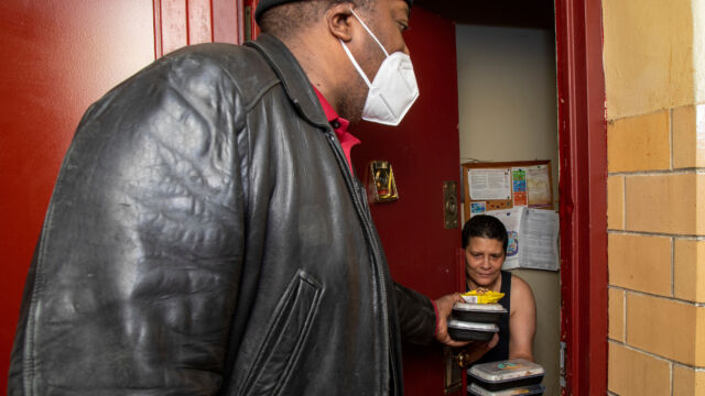 St. Nicholas Houses Resident Association President Tyrone Ball helped distribute holiday meals to residents.