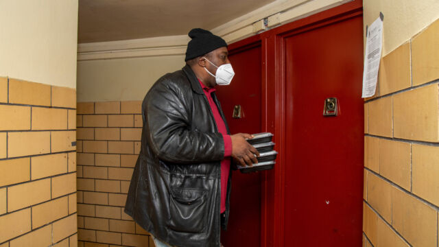 St. Nicholas Houses Resident Association President Tyrone Ball helped distribute holiday meals to residents.