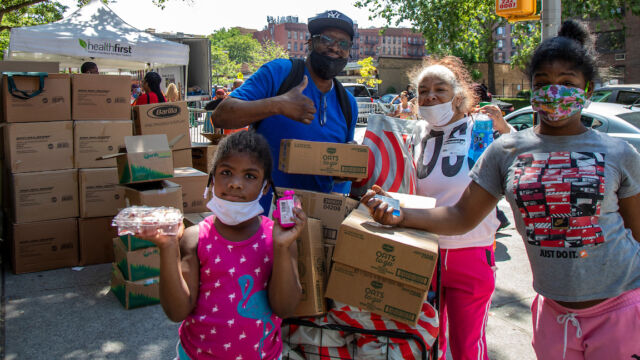Juneteenth Food Distribution at Lincoln Houses four people with boxes of groceries
