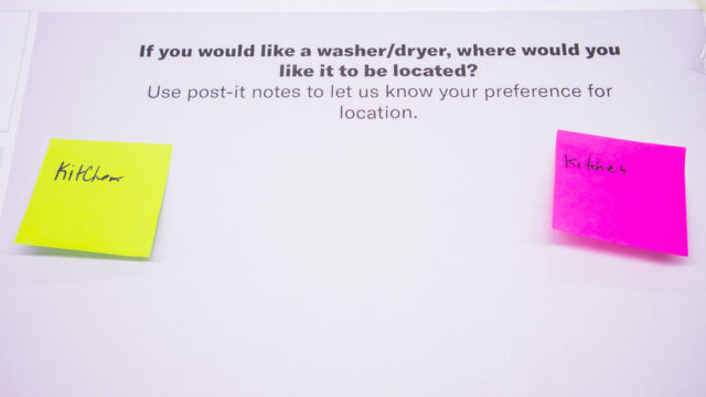 post it notes, residents noting whether they would like a new washer/dryer in the kitchen or other place. two post its say kitchen