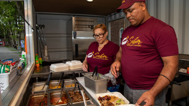 Preparing food for customers. man and woman with food