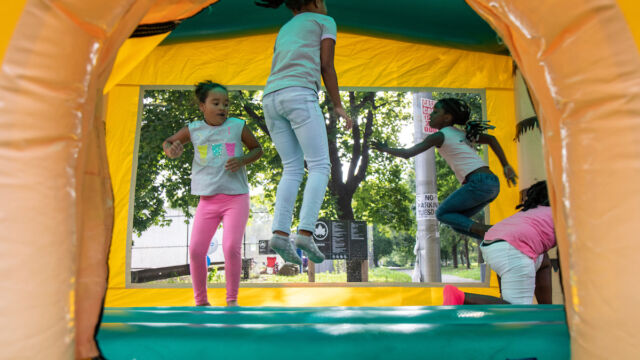 National Night Out Monroe Houses children jumping in bouncy house
