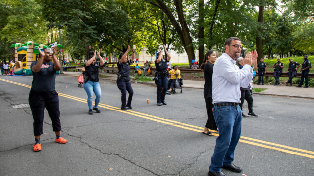 National Night Out Monroe Houses people dancing outside in the street