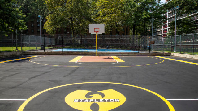 Designed with input from residents, the Stapleton Houses basketball court incorporates the logo of famed Staten Island hip hop group Wu-Tang Clan. Stapleton basketball court opens