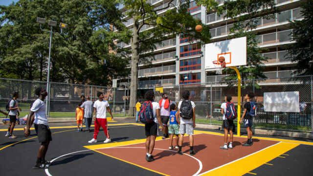 Local youth are among the first to test out the refurbished play space. Youth play at Stapleton court