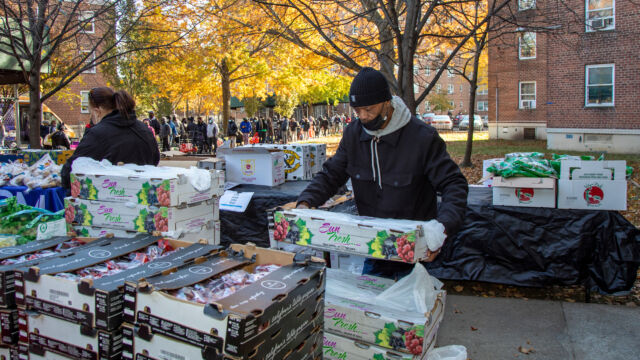 Thanksgiving Food and Turkey Distribution at Breukelen Houses man putting out food