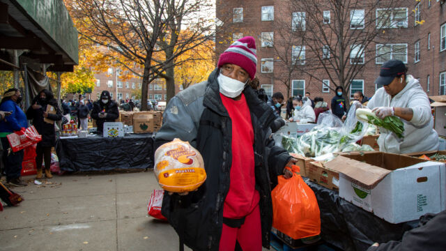 Thanksgiving Food and Turkey Distribution at Breukelen Houses man with a turkey