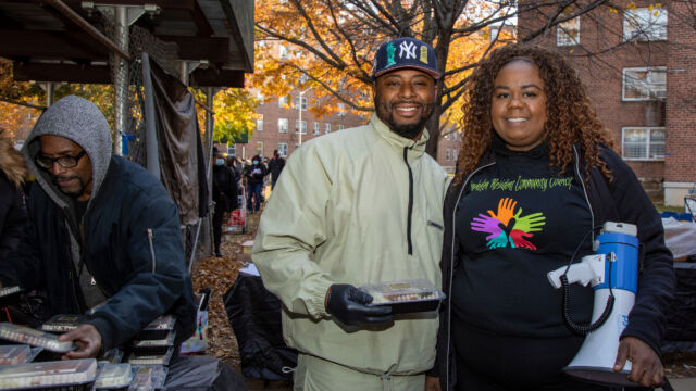 Thanksgiving Food and Turkey Distribution at Breukelen Houses two people outdoors