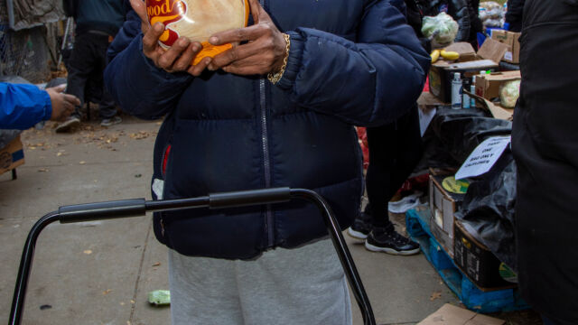 Thanksgiving Food and Turkey Distribution at Breukelen Houses person holding up a turkey