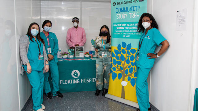 Ribbon Cutting Ceremony for Astoria Houses Floating Hospital group of people wearing medical scrubs and masks