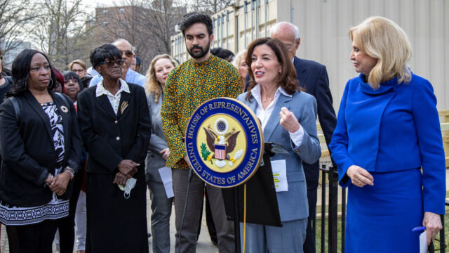 Ribbon Cutting Ceremony for Astoria Houses Floating Hospital woman: Governor Hochul at podium with group of people