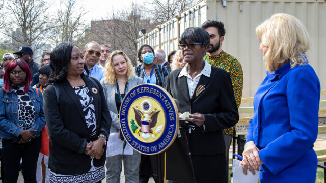 Ribbon Cutting Ceremony for Astoria Houses Floating Hospital Woman at podium with group of people