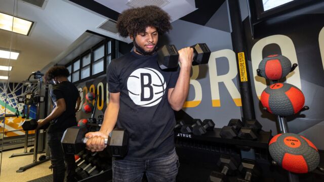Community youth are excited to return to working out in the new fitness room, which features weight equipment, treadmills, and a bicycle machine.
