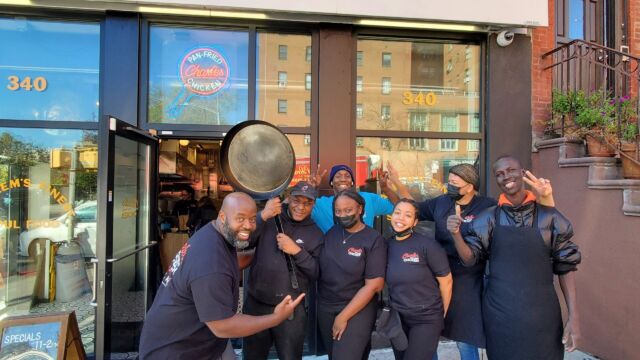 group of people standing outside a restaurant