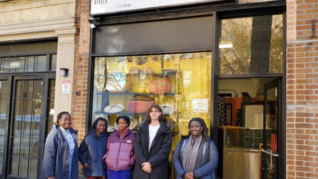group of people standing outside a restaurant
