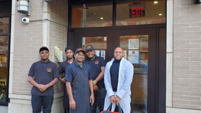 group of people standing outside a restaurant